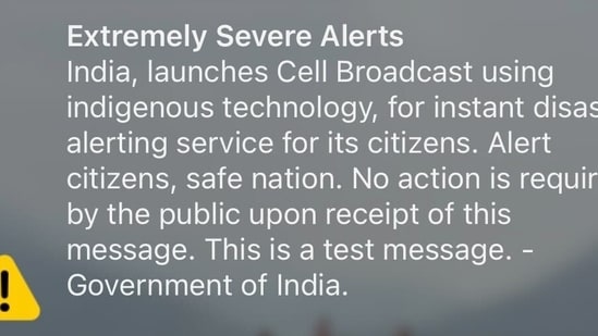 A group of professionals reacting to an emergency alert system test on their phones.