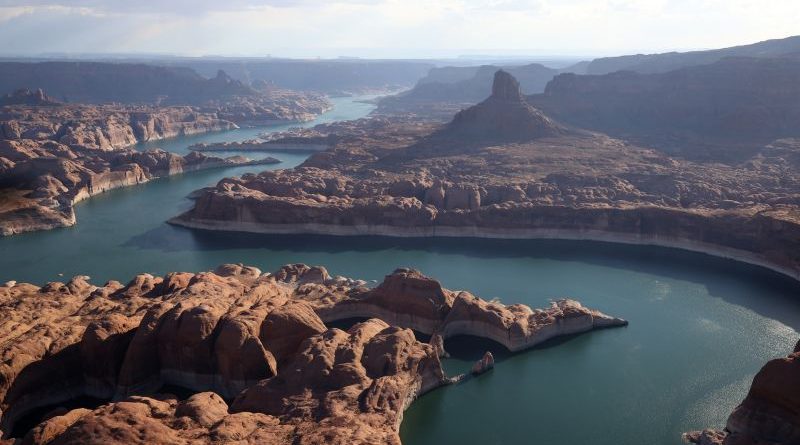 Lake Powell water levels decline, showcasing exposed shorelines and management discussions.