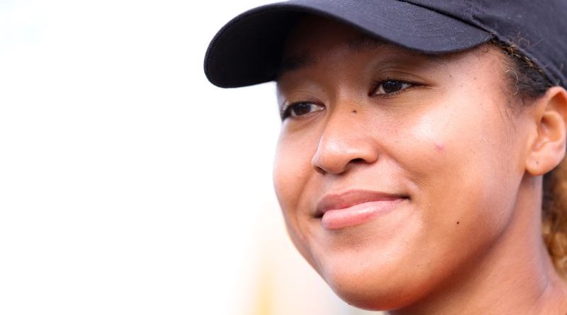 Group of professionals celebrating Naomi Osaka pregnancy news in an office.