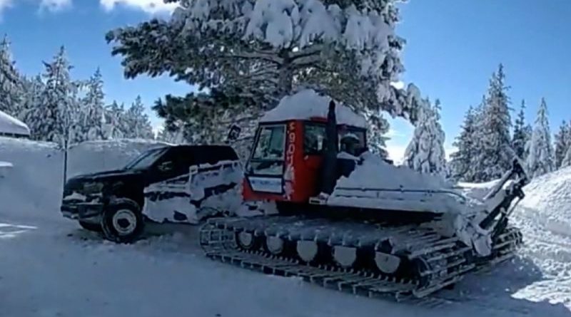 Emergency responders assist Jeremy Renner at a snowplow accident scene.