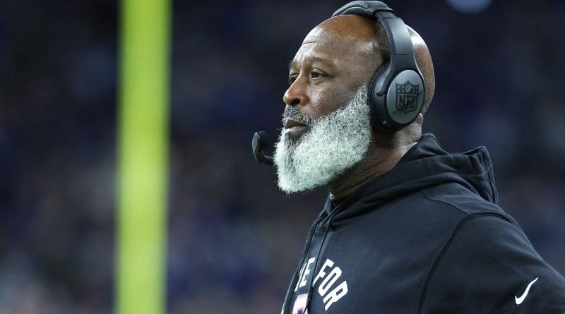 A diverse group of NFL coaches discussing strategies, emphasizing NFL coaching diversity.