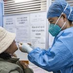 Scientists conducting research on a nasal Covid-19 vaccine in a laboratory.
