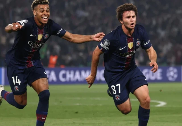 Excited fans in a soccer stadium celebrating PSG's potential French championship win.