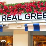 Concerned restaurant staff discussing the Real Greek restaurant crisis.