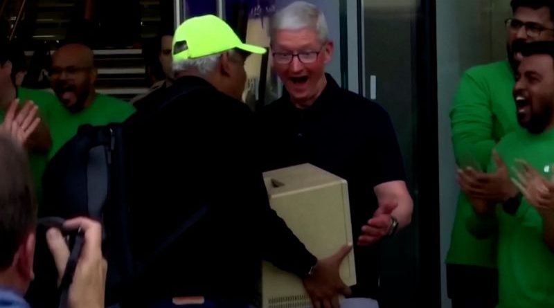Customers engaging in the Apple store opening, highlighting the Apple store opening in Mumbai.