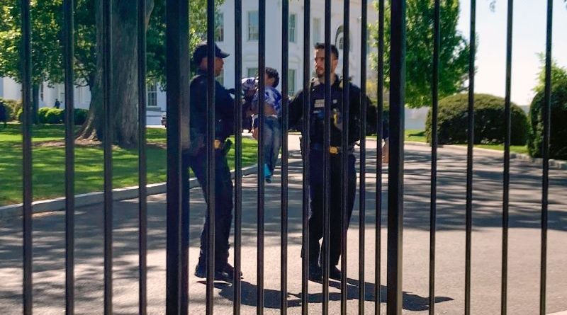 Security personnel monitor the area around the White House after a toddler breaches security.