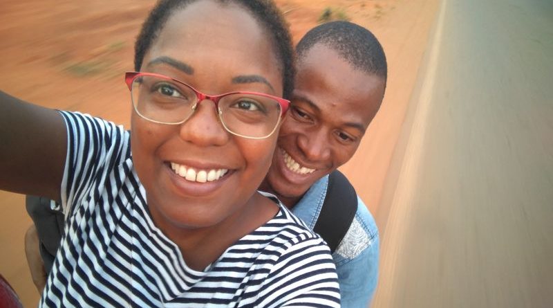 A happy couple celebrating their engagement story in Benin's vibrant market.