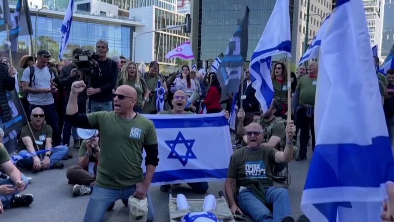 Israeli military veterans protesting for change, holding flags in solidarity.