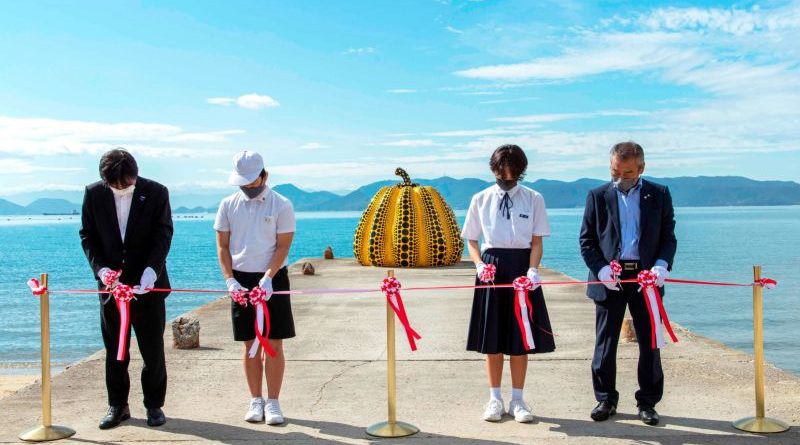 Yayoi Kusama pumpkin sculpture on Naoshima Island with visitors.