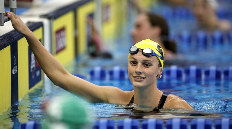Young swimmer Summer McIntosh in a competitive swimming pool setting.